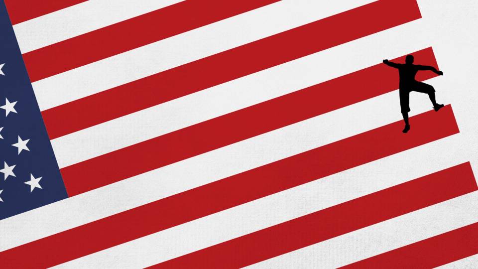 A silhouetted person climbing up the stripes of the American Flag