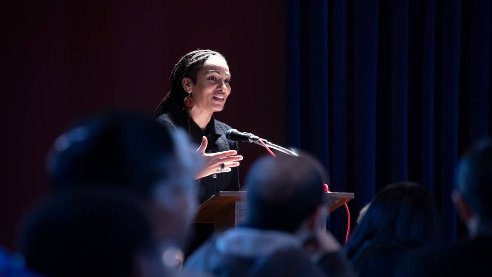 Ruha Benjamin speaking at podium