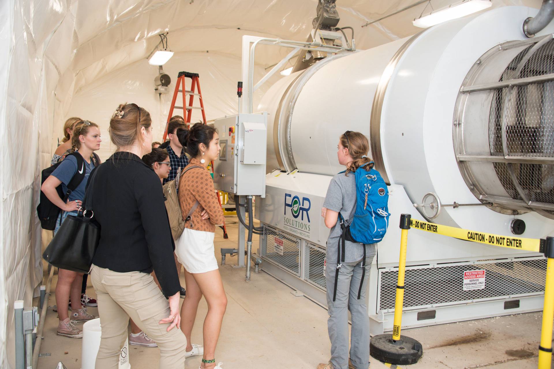 Students and staff touring biodigester