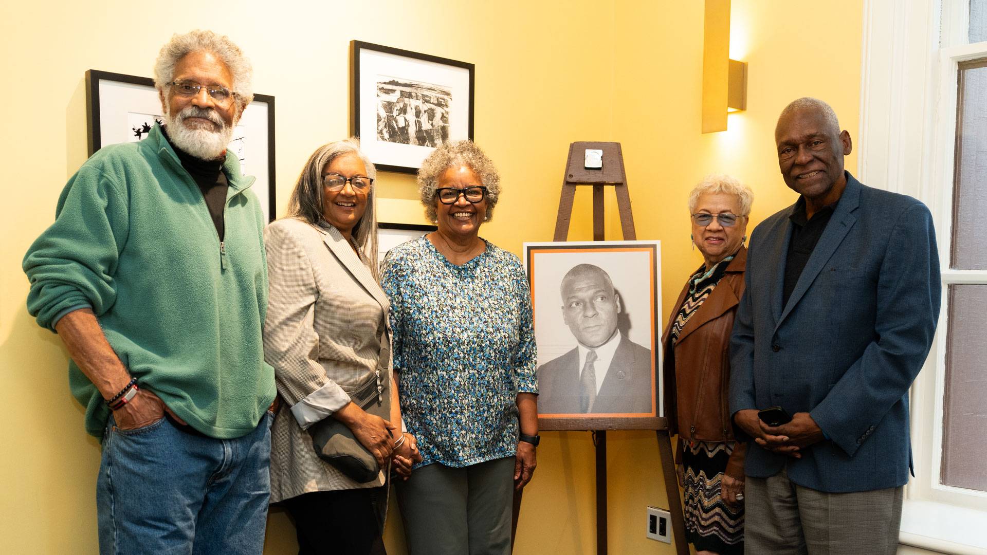 Family and friends stand with photo of Bruce Wright 
