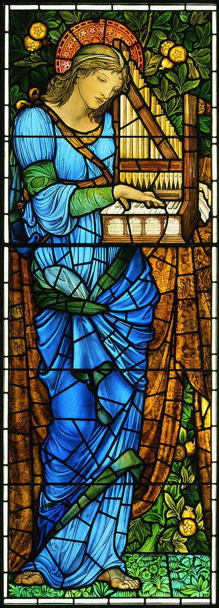 Stained glass window featuring a woman reading a book